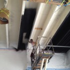 Permalink to Commercial Warehouse Ceiling Painting in North Vancouver Applying first coat of Dryfall paint to commercial warehouse ceiling
