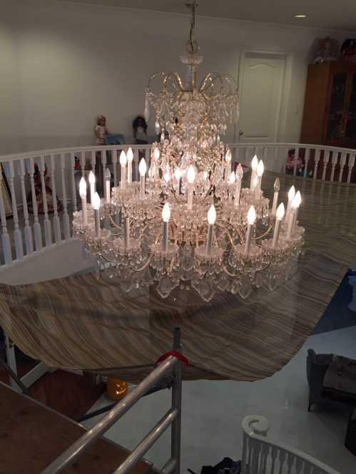 dirty crystal chandelier during cleaning by A Glass Act